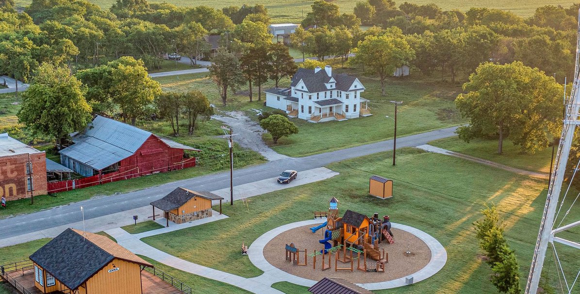 An aerial view of a park and playground in Anna, Texas at golden hour
